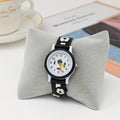 Children's watch with soccer design on a gray cushion