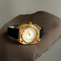 women's wrist watch with dark brown leather strap with gold watch face